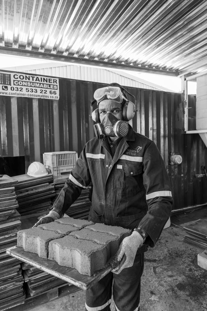 EWaste Africa staff member wearing full respiratory and eye protection, reflecting OHSA-compliant facility practices